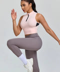 Woman exercising in cropped workout tank for women with built in bra half zip high neck sports top medium support sleeveless gym gear in Chintz Rose