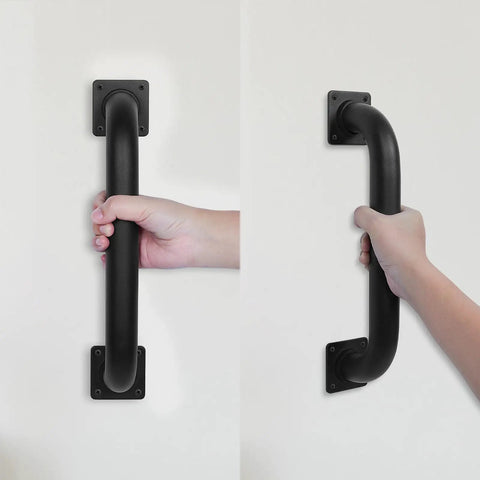 Heavy Duty 12 Inch Square Matte Black Staircase Handrails In A Two Pack Feature Solid Steel Construction For Indoor And Outdoor Step Support With Wall Mount Safety Grab Bars And Smooth Gate Handles Built Like A Damn Tank To Catch You Securely On Slippery, showing hand gripping a sturdy matte black handrail.