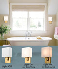 Gold Mid Century Wall Sconces Set Of 2 with white linen shade displayed in a bathroom, showing light off and on in day and night settings.