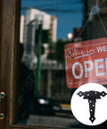 4 Pack Heavy Duty Iron Barn Door Strap Hinges With Matte Black Finish Eight Pre Drilled Mounting Points Quick Grip Install Rock Solid Hardware For Interior Wood Doors Outdoor Gates Smooth DIY Projects displayed near an open sign on a door.