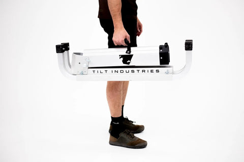 Carrying the folded Bike Balance Trainer And Repair Stand Combo for Cyclists Build Core Stability Quick Reaction Time And Full Body Strength