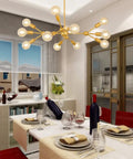 Modern Sputnik Chandelier 12 Light Gold Metal Ceiling Fixture for Living Room Bedroom Dining Kitchen and Office Dope Statement Lighting with E26 Base LED Compatible Bulbs Not Included 38.6 Inch Diameter above dining table