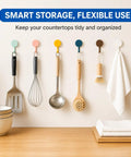 Sixteen Pack Dead Easy Colorful Adhesive Wall Hooks Self Stick Strong Tape No Drill Renter Friendly Low Key Decorative Style Quick Mount Organization For Any Space Major Room Refresh hanging kitchen tools on a wall.