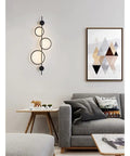 Top Shelf Modern Wall Sconce With Straight Fire Led Glow And Hella Sturdy Iron Frame illuminating a cozy living room setting.