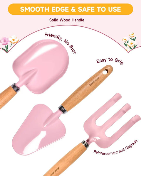 Pink shovel, trowel, and rake with wood handles from Eight Piece Kids Gardening Tool Set With Shovel Rake Watering Can Hat Apron Gloves And Storage Bag Pink Flower Theme Real Tools For Toddlers And Kids In A Fun Handcrafted Style.