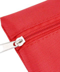 First aid kit bag, red fabric with metal zipper pull, close-up view