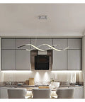 Upgrade Your Digs With This Slick Wave Shaped LED Pendant Light Boasting A Premium Gold Chrome Plated Finish Perfect For Restaurants Kitchens And Chill Dining Spaces in a modern kitchen.