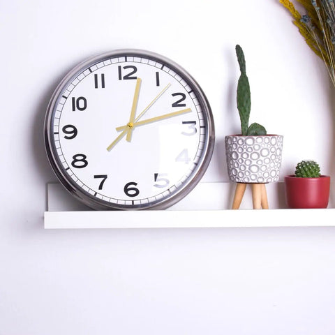 Wall clock with Metal Clock Hands Replacement Kit 10 Sets Handy DIY Wall Clock Hands, gold hands on shelf with plants.