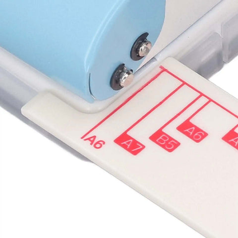 Close-up of Handheld Three Hole Paper Punch With Scrap Collector Workhorse showing paper size guide for A6, A7, B5