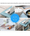 Mobile Workstation Lap Desk With Height Adjustable Wheels And Non Slip Bezel Edge Rolling Computer Table For Breakfast In Bed on couch with laptop.