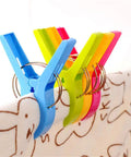 Heavy Duty Beach Towel Clips for Chairs and Loungers securely holding towels with colorful, windproof design.