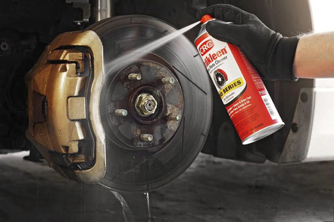 CRC Brakleen brake cleaner spray can aimed at a car brake rotor and bronze brake caliper (29 oz Pro Series)