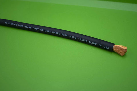 Close-up of premium #2 copper welding cable for Beefy Heavy Duty Battery Jumper Cables Set With Premium Copper Number 2 Welding Cable 12 Foot Length 500 Amp Clamps On Both Ends Red And Black Vehicle Jump Cables For Quick Starts And Emergency Power on green background showing cable marking."