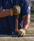Worker using Go To Lineman 26 Ounce Claw Milled Hammer With Fiberglass Handle on utility pole