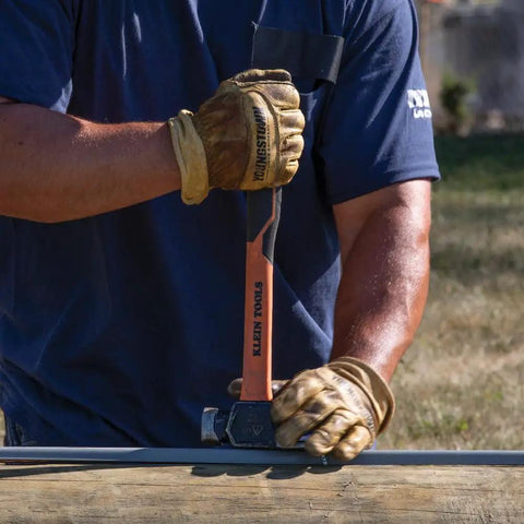 Worker using Go To Lineman 26 Ounce Claw Milled Hammer With Fiberglass Handle on utility pole