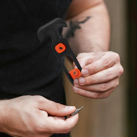 Man holding a black and orange Beefy Rubber Flexible T Handle Hasp Draw Latch For Car Hood Toolbox And Truck Doors 2 Pack Replacement
