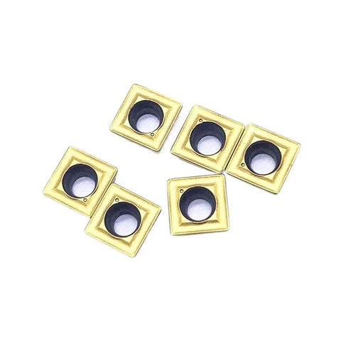 Premium 10Pc Indexable Carbide Lathe Tool Set With SPMG060204 Inserts close-up of six gold and black carbide inserts for CNC machining.