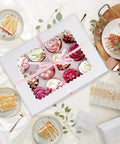 Top view of white six-pack cupcake boxes that hold 12 standard cupcakes with clear windows, food safe paper bakery carriers.
