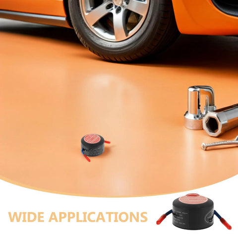 Two Pack Self Activating Fire Extinguisher Stickers No Sweat Auto Fire Defense on garage floor next to car tools.