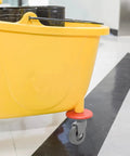 4 Piece Heavy Duty Rubber Swivel Caster Wheels With Threaded Stem And Spring Loaded Setup For Slick Rolling On Mop Buckets Trash Dolly Furniture Carts Grey on a yellow mop bucket