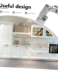Kitchen with white cabinets and an inset image of a concealed hinge on the top right corner labeled 'Useful design.'
