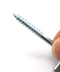 Close-up of Hardcore Zinc Plated Square Bend Hook M5 Lag Screw held between fingers, showcasing its heavy-duty carbon steel design.