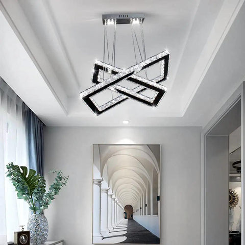 Lit LED Two Ring Rectangular Crystal Chandelier Pendant Light in stainless steel, hanging from ceiling in modern living room