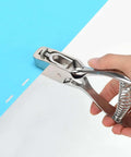 Tough As Nails Heavy Duty Handheld Hole Punch for ID cards and PVC, zinc alloy build, cutting through blue paper with oval slot design