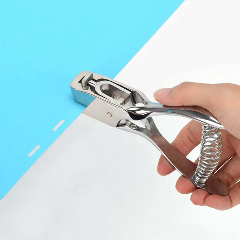 Hand using Tough As Nails Heavy Duty Handheld Hole Punch for ID cards and plastic PVC cardstock with zinc alloy and sharp blade edge