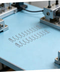 Two Pack Industrial Trapezoidal Flat Compression Springs 1x9.5x35x160mm on machinery table