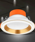 WKNHHL Recessed Lighting Housing Trim Kits Round Led Downlight Recessed Ultra Slim Chrome Aluminum Spotlight Commercial Clothing Mall Market Panel Ceiling Lights,White Ligh,Whit with orange trim and gold accents.