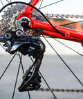 Close-up of rear derailleur with All In One Universal Bike Cable Replacement Kit for Shifting and Braking on road bike.