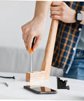 Close-up of installing Veemoon folding hinge on wooden table leg; orange screwdriver and black hinge visible.