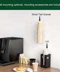 Disposable Coffee Cup Dispenser With Easy Grab Handles For Countertop Or Wall Mount Holds 3.54 Inch Dia Cups and Lids Up To 16 Oz Acrylic Lid Storage Organizer In Clear For Home Office Kitchen shown with cups and coffee machine.