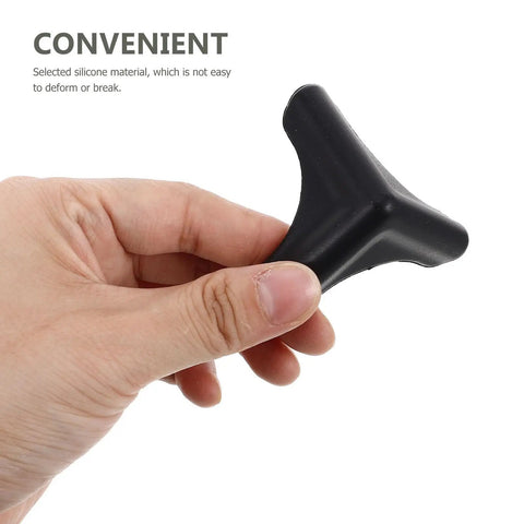 Hand holding silicone corner protector from Silicone Corner Protectors 4 Pack For Kitchen Tables And Furniture Edges Edge Guards