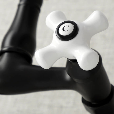Close-up of Vintage Center Wall Mount Kitchen Faucet in Matte Black with adjustable spacing, brass handle detail