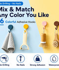 Colorful adhesive wall hooks holding towels and utensils, showcasing Sixteen Pack Dead Easy Colorful Adhesive Wall Hooks Self Stick Strong Tape No Drill Renter Friendly Low Key Decorative Style Quick Mount Organization For Any Space Major Room Refresh.
