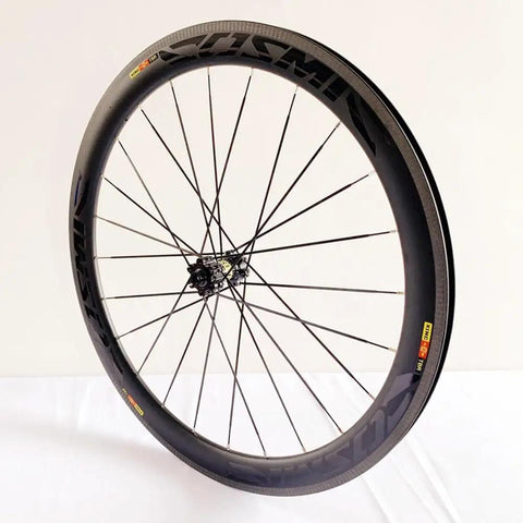 Carbon Fiber 700C Road Bike Wheel Set With 50mm Clincher Rim, in a side angle showing disc brake compatibility and DT Tooth 36T Hub.