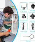 Man using electric drain cleaner under sink with various cutter heads displayed. Slash Your Plumbers Bill By Crushing Stubborn Kitchen And Bath Drain Clogs With This Heavy Duty Electric Drain Cleaner Cutter Head Kit Built To Blast Through Hair Grease Daily.