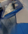 Worker using Metallic Colored Epoxies 18 Inch Epoxy Trowel Spreader Tool for smooth application on blue epoxy floor