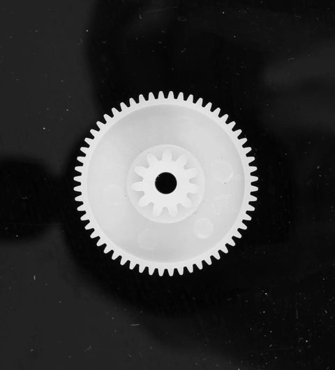 Close-up of white plastic gear from 550 Gear Box Set For Kids Must Have Ride On Car Replacement Gears Kit Large Middle Small Drive Gears