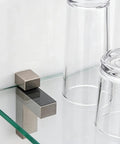 Four Pack Mini Brushed Zinc Alloy Glass Shelf Clamps With Rubber Cushions fixing a glass shelf, clear glasses on top