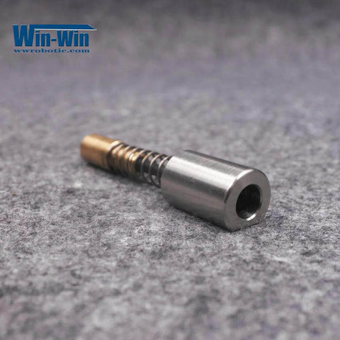 Electronic shift actuator assembly for waterjet machines; metal cylinder with brass tip and coil spring (front view).