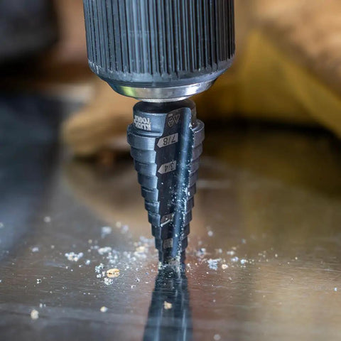 Step Drill Bit 14 Double Fluted 3/16 to 7/8 Inch with Easy Read Step Markings drilling through metal surface.