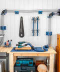 Premium Rockler Dust Right 4 Inch Hose Cradles mounted to workshop wall, supporting dust hoses and tools for ventilation.