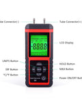 Front view of EHDIS digital manometer for HVAC, handheld black/red unit with dual tube connectors and green LCD display.