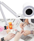 Top Tier Nail Dust Collector Machine With Integrated Lamp And Badass Suction Fan For Manicurists And Home Salon Crews in use during manicure.
