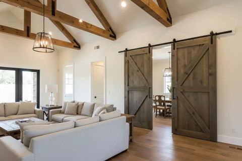 Give Your Place A Badass Upgrade Using Rustic Walnut Reactive Water-Based Interior Wood Stain, A Heavy-Duty VOC-Free Workhorse Delivering Serious Punch For Deep Rich Tones And Aged Wood Vibe On One Jumbo 55-Gallon Drum, showcasing rustic barn doors in a modern living room.