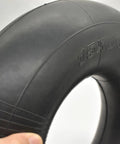Person holding a Heavy Duty 15x6-6 Inner Tube Two Pack With TR-13 Straight Valve for 15x6.00-6 Tires.