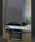 Heavy Duty Tabletop Tape Dispenser With Automatic Carton Sealer Stand showing measuring tape on the base for size reference.